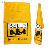 Golden yellow golf towel with Bell's Logo and Inspired Brewing printed on it. Same towel featured hanging on the right.