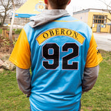 blue baseball jersey with golden sleeves and Oberon patch across back and large black 92 