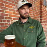 green corduroy button up shirt with orange plaid elbow patches and embroidered "Two Hearted IPA" over pocket.  