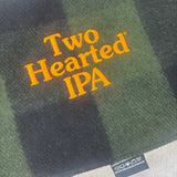 Green buffalo check wool blanket with orange embroidered "Two Hearted IPA on bottom right corner
