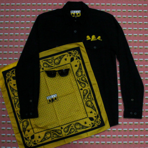 Black Bell's western shirt with 3 bells on the front left chest pocket. Yellow and black Bell's bandana and yellow and black Bell's sunglasses.