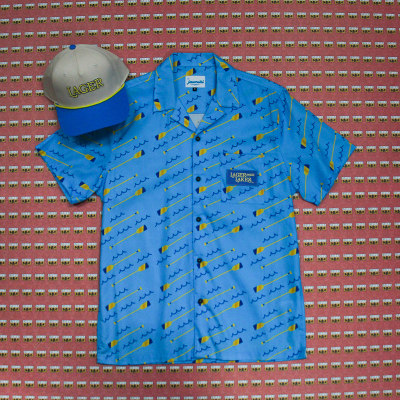 Lager of the Lakes blue button up with waves and oars. Lager rope hat, blue bill with cream base hat and yellow rope. 