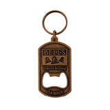 A bottle opener keychain made of a bronze metal with the Bell's logo and the words "Inspired Brewing" and "USA MADE."
