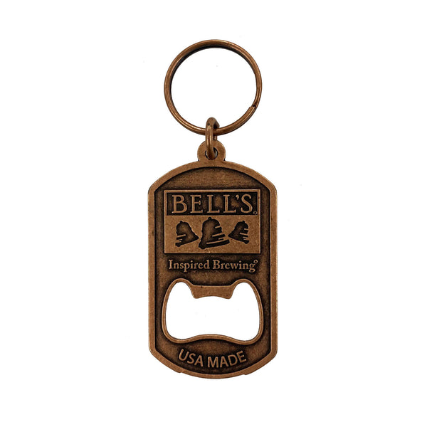 A bottle opener keychain made of a bronze metal with the Bell's logo and the words "Inspired Brewing" and "USA MADE."