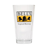Clear pint glass with yellow and black Bell's logo. Inspired Brewing tagline in black beneath.
