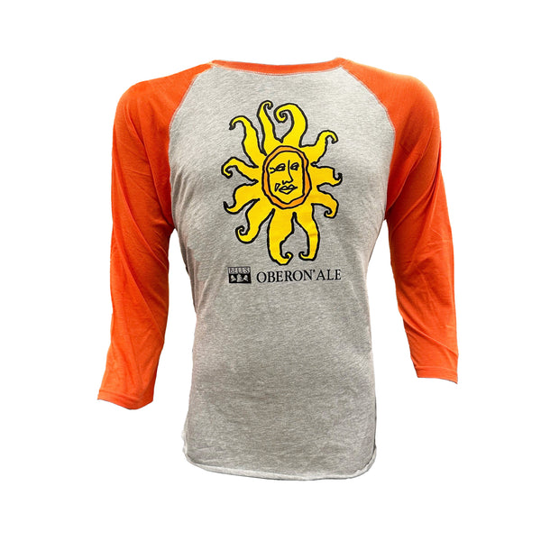 A raglan t-shirt with orange 3/4 sleeves, a heather gray body, and the Oberon Ale sun screen printed on the chest with the words “Oberon Ale” below in black next to the Bell’s logo.