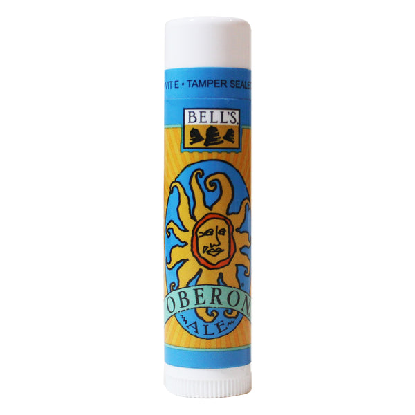 Lip balm tube with light blue background and Oberon Ale logo. Has a Tamper seal.